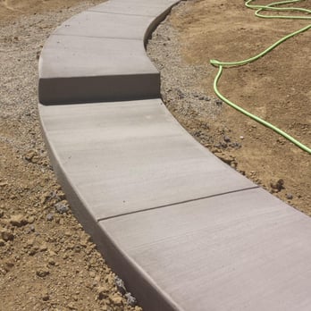 Cesars Concrete - Sidewalk with step down from garage door to patio. Poured with colored cement. - Masonry/Concrete Near Me - Loveland, Colorado Cesars Concrete - Sidewalk with step down from garage door to patio. Poured with colored cement. - Masonry/Concrete Near Me - Loveland, Colorado