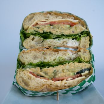 Glowing - Chickpea Tuna Sandwich: Homemade chickpea tuna salad, vegan cheese,  seasonal greens, tomatoes, pickles, onions, vegan mayo, and cucumber on - Health Markets Near Me - Los Angeles, California