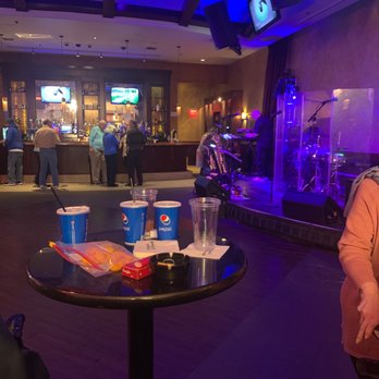 Rocks Lounge - a woman sitting at a table with drinks - Music Venues Near Me - Michigan City, Indiana Rocks Lounge - a woman sitting at a table with drinks - Music Venues Near Me - Michigan City, Indiana