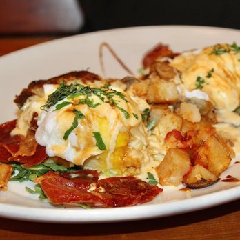 Acova - The Italian Benedict was made with two eggs, prosciutto, greens, basil, sun-dried tomato hollandaise, balsamic, polenta cakes, & potatoes. - New American Near Me - Denver, Colorado Acova - The Italian Benedict was made with two eggs, prosciutto, greens, basil, sun-dried tomato hollandaise, balsamic, polenta cakes, & potatoes. - New American Near Me - Denver, Colorado