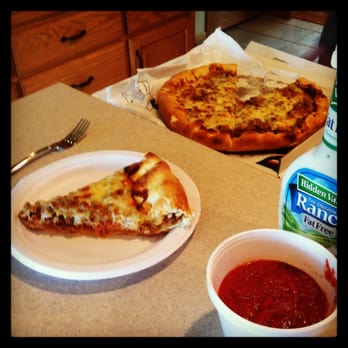 Key Pizza - a slice of pizza on a plate next to a bowl of ketchup - Pizza Near Me - Hammond, Indiana