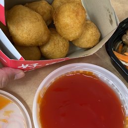 a box of fried food and a container of sauce a box of fried food and a container of sauce