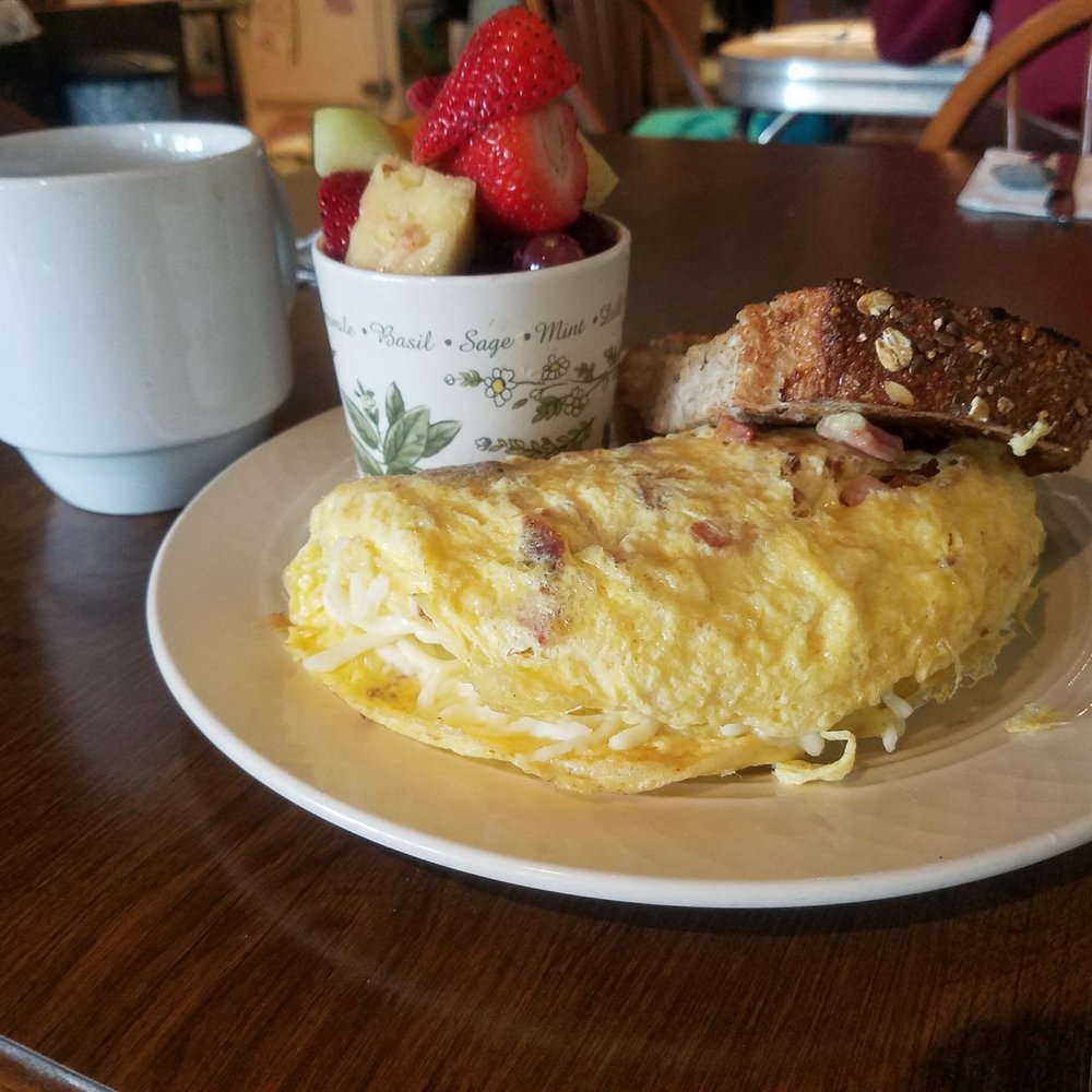 Ham bacon cheese omelette, fresh fruit, 9 grain toast and coffee. Amazing!!!