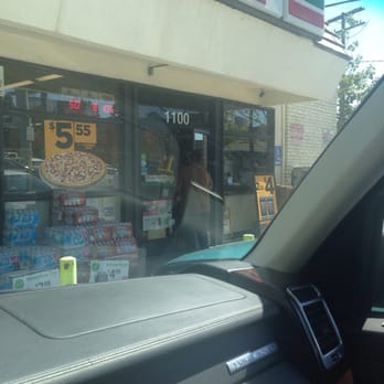 7-Eleven - a view of a pizza shop from inside a car - Convenience Stores Near Me - West Hollywood, California