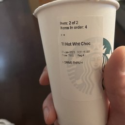 a hand holding a cup of coffee a hand holding a cup of coffee