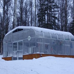 Sunglo Greenhouses - 2100E Model on raised foundation and double doors