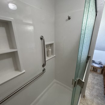 Precision Home Improvement - a bathroom with a glass shower door - General Contractors Near Me Precision Home Improvement - a bathroom with a glass shower door - General Contractors Near Me