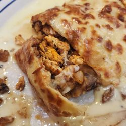 El Maguey Mexican Restaurant - A closeup of the Quesa Ballena. Not on the menu. Chicken, steak, shrimp, mushroom quesadilla with a mild chipotle cheese sauce on top.