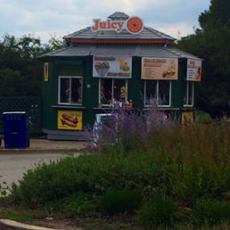 a green building with a sign that says juicy