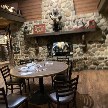 Alibi - a table and chairs in a restaurant - Pizza Near Me - Troy, Michigan