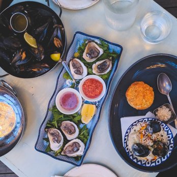Blue Mussel Cafe - L - R: Beer and lime mussels (L), Daisy Bay oysters with mignonette, and seafood chowder with cheddar biscuit and maple butter - Seafood Near Me - Rustico, Prince Edward Island Blue Mussel Cafe - L - R: Beer and lime mussels (L), Daisy Bay oysters with mignonette, and seafood chowder with cheddar biscuit and maple butter - Seafood Near Me - Rustico, Prince Edward Island