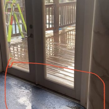 Honest Abe Roofing Orlando - Rain water on floor huddling near pillar and door from leaks in ceiling/ roof - Roofing Near Me - Orlando, Florida Honest Abe Roofing Orlando - Rain water on floor huddling near pillar and door from leaks in ceiling/ roof - Roofing Near Me - Orlando, Florida