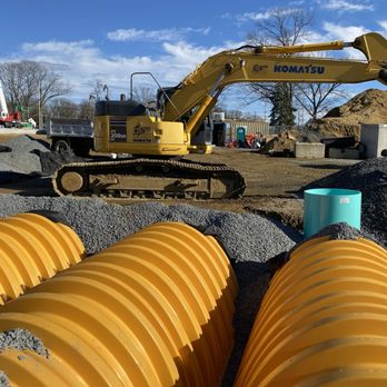 Furino & Sons - a construction site with pipes and a bulldozer - General Contractors Near Me - Branchburg, New Jersey Furino & Sons - a construction site with pipes and a bulldozer - General Contractors Near Me - Branchburg, New Jersey