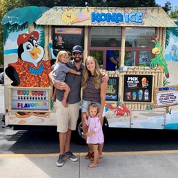 a family standing in front of a food truck