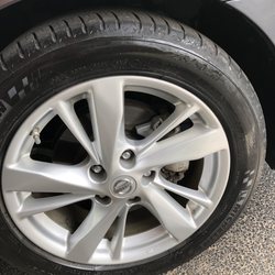 Expresso Car Wash - Uneven application of tire dressing and dirty spots on rim.
