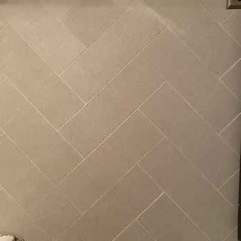 JC Tile & Countertops - Perfect floor transition with a Schluter piece from hallway to bathroom - Tiling Near Me