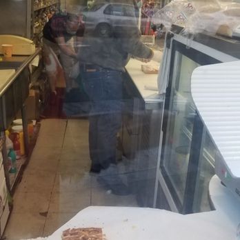 White Palace Liquor Store - employee eating sandwich between making sandwiches - Beer, Wine & Spirits Near Me - San Francisco, California