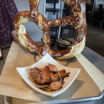 Outpost 611 Eatery & Taphouse - Mega Bavarian pretzel with side of bratwurst - American Near Me - Clearwater, Florida