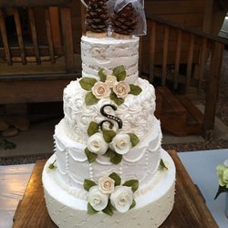 Silver Rose Bakery - cabin in forest white wedding - three tier cake with fourth tier dummy - ivory roses - heart topper and pine cone bride and groom topper - 2