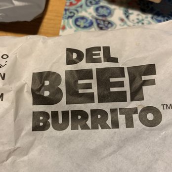 Del Taco - a bag of burrito sitting on a table - Tex-Mex Near Me - Richland, Washington Del Taco - a bag of burrito sitting on a table - Tex-Mex Near Me - Richland, Washington