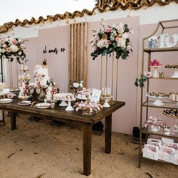 Amigo Event Rentals - Antique Vineyard table, Gold Shelving, various risers, and cake stands.