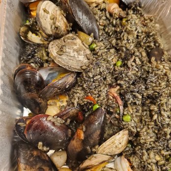 Paella - clams, rice, and vegetables in a plastic container - Spanish Near Me - Norwalk, Connecticut