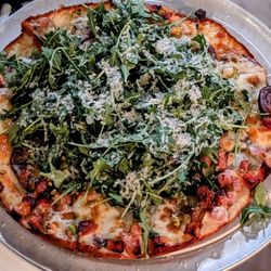 Cellarmaker Brewing Company - Mortadella & Potato Pizza on GF crust Mortadella, purple potato, pistachio pesto, rosemary black peeler honey, arugula and Parm.