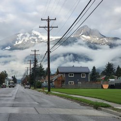 Drive About Car Rental - Skagway view of the mountains along the edge of the ocean and draped in cloud ribbons.