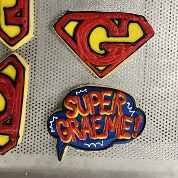 Cookies By Design - superman cookies with the word super - Bakeries Near Me - Exton, Pennsylvania Cookies By Design - superman cookies with the word super - Bakeries Near Me - Exton, Pennsylvania