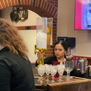 El Rancho Nuevo - a woman pouring a drink at a bar - Mexican Near Me - Saint Charles, Missouri El Rancho Nuevo - a woman pouring a drink at a bar - Mexican Near Me - Saint Charles, Missouri