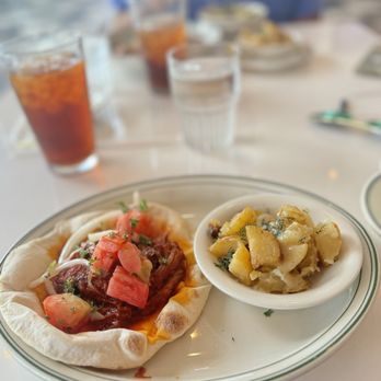 Tasty Town - Braised lamb pita sandwich with lemon potatoes. Pita is super fresh and braised lamb with onions and tomatoes made for a great sandwich. - Greek Near Me - Birmingham, Alabama Tasty Town - Braised lamb pita sandwich with lemon potatoes. Pita is super fresh and braised lamb with onions and tomatoes made for a great sandwich. - Greek Near Me - Birmingham, Alabama