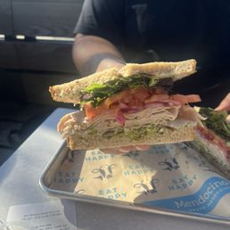 the farm club: roasted turkey, avocado, applewood smoked bacon, tomatoes, red onions, greens, herb aioli on whole wheat = $13.95 the farm club: roasted turkey, avocado, applewood smoked bacon, tomatoes, red onions, greens, herb aioli on whole wheat = $13.95