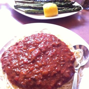 Minerva Restaurant - Spaghetti with meat sauce and grilled asparagus in the background - Pizza Near Me - Vancouver, British Columbia
