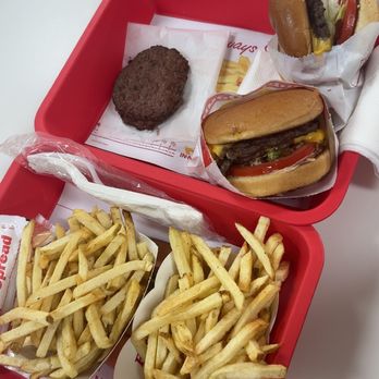 In-N-Out Burger - one cheese burger with grilled onion and raw onion. one double double with cut up chilli and grilled onion. two fries. two puppy patties. - Burgers Near Me - Pleasanton, California