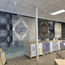 Jordans Flooring - A small selection of our area rugs hanging on display