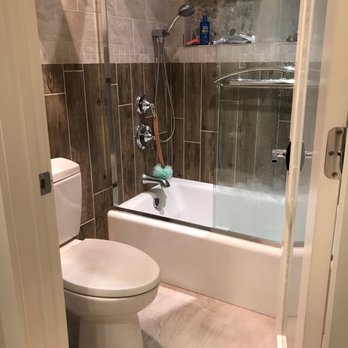 Bellari Home Remodeling - Toilet/bath area. Note the tile that looks like slats of wood. - Windows Installation Near Me - Branchburg, New Jersey