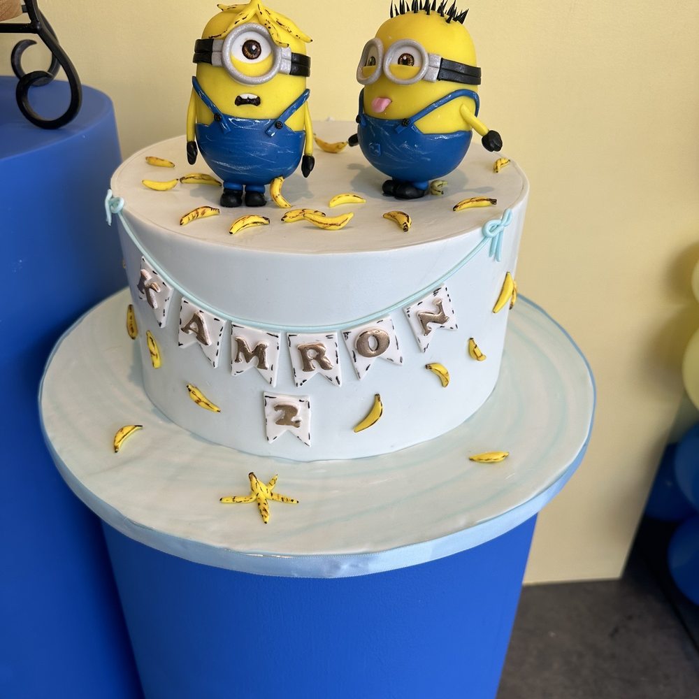 Rose Bakery - a cake with two minion figurines on top - Custom Cakes Near Me Rose Bakery - a cake with two minion figurines on top - Custom Cakes Near Me
