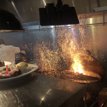 Weber Grill Restaurant - Grill master just tossed on a full chimney of coals - Steakhouses Near Me - Indianapolis, Indiana