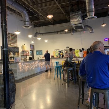Ironmonger Brewing & Distilling - a man sitting at a bar - Axe Throwing Near Me - Marietta, Georgia Ironmonger Brewing & Distilling - a man sitting at a bar - Axe Throwing Near Me - Marietta, Georgia