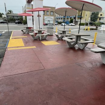 Original Tommy's - Concrete tables/seating with umbrellas in the front. - Burgers Near Me - Long Beach, California