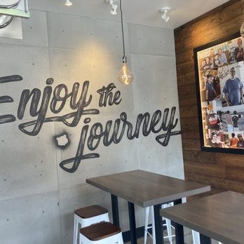 MOD Pizza - a wall with a sign that says enjoy the journey - Pizza Near Me - Denver, Colorado