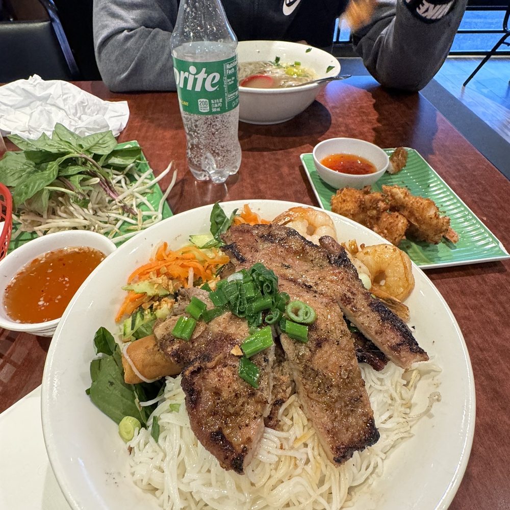 Grilled pork with egg rolls and shrimp noodle vermicelli bowl Grilled pork with egg rolls and shrimp noodle vermicelli bowl