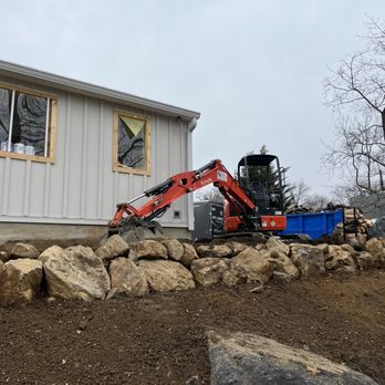 VIP Landscaping - a small excavator in front of a house - Landscaping Near Me - Havertown, Pennsylvania VIP Landscaping - a small excavator in front of a house - Landscaping Near Me - Havertown, Pennsylvania