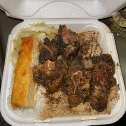 Famous Jamaican Jerk & Seafood - Oxtails , Jerk Chicken. White rice , Mac & Cabbage