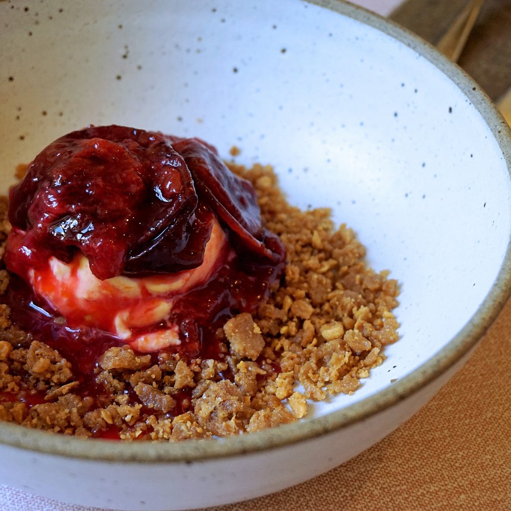 Acorn Vegetarian Kitchen - Stewed plums, brandy ice cream, almond crumb (£8.25). - Vegetarian Near Me - Bath, BAS Acorn Vegetarian Kitchen - Stewed plums, brandy ice cream, almond crumb (£8.25). - Vegetarian Near Me - Bath, BAS
