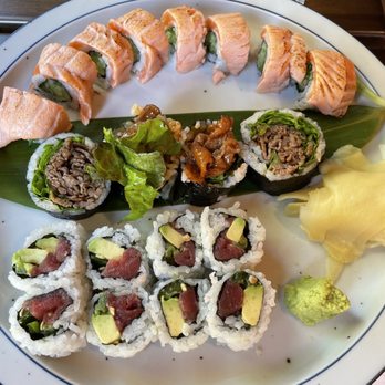 Wasan Brooklyn - "Aburi" Torched Salmon Roll, BBQ Roll, tuna avocado roll - A large sushi platter featuring salmon-topped rolls, beef and vegetable rolls, and avocado rolls, with pickled ginger and wasabi. - Japanese Near Me - Brooklyn, New York