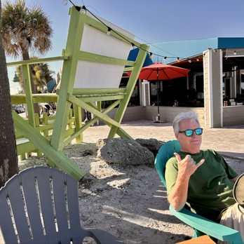 Mulligans Beach House Bar & Grill - outdoor bar area. My husband, Jim, enjoying his time after our drinks and fish. - Seafood Near Me - Vero Beach, Florida