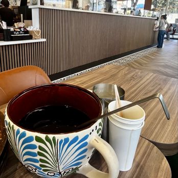 Con Azucar Cafe - A pot-sized coffee cup with a ladle, sure to be enough for the whole family. - Coffee & Tea Near Me - Hayward, California