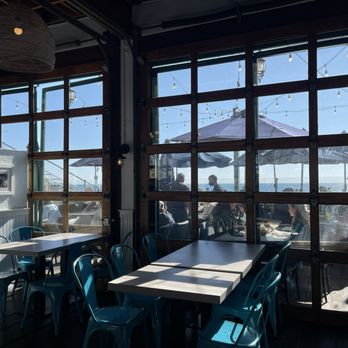 Maria Sol - tables and chairs in a restaurant with a view of the ocean - Mexican Near Me - Santa Monica, California