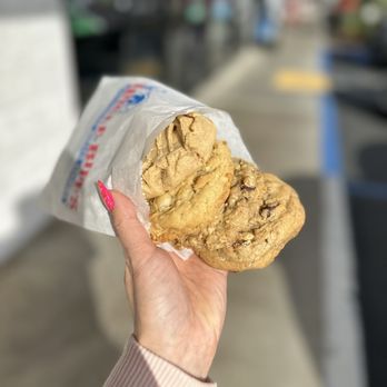 Uncle Biff's California Killer Cookies - a hand holding a cookie - Bakeries Near Me - San Diego, California Uncle Biff's California Killer Cookies - a hand holding a cookie - Bakeries Near Me - San Diego, California
